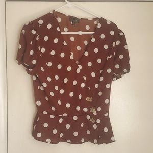 Polka dot peplum top in rust marked as L fits like a M